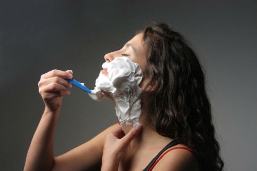 Женщина бреет лицо